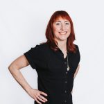 Red head woman looking and smiling at the camera